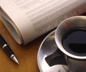 pen, newspaper and coffee cup Showing pen, newspaper and coffee cup