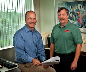 two men in a office showing two men in a office