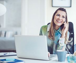 Showing a woman on the mobile phone and here laptop